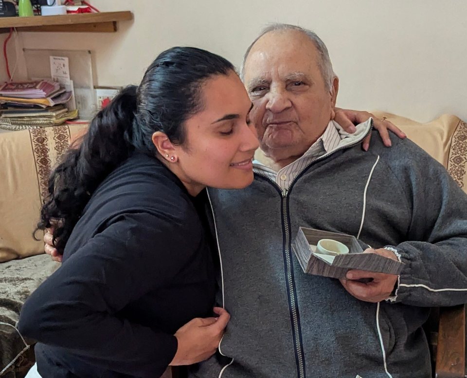 Goonja embracing her grandfather in Ahmedabad, India.